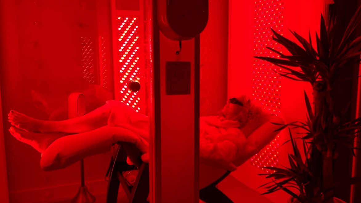 The red-light-therapy suite at NeuCognition Centers, showing non-invasive technology and warm atmosphere